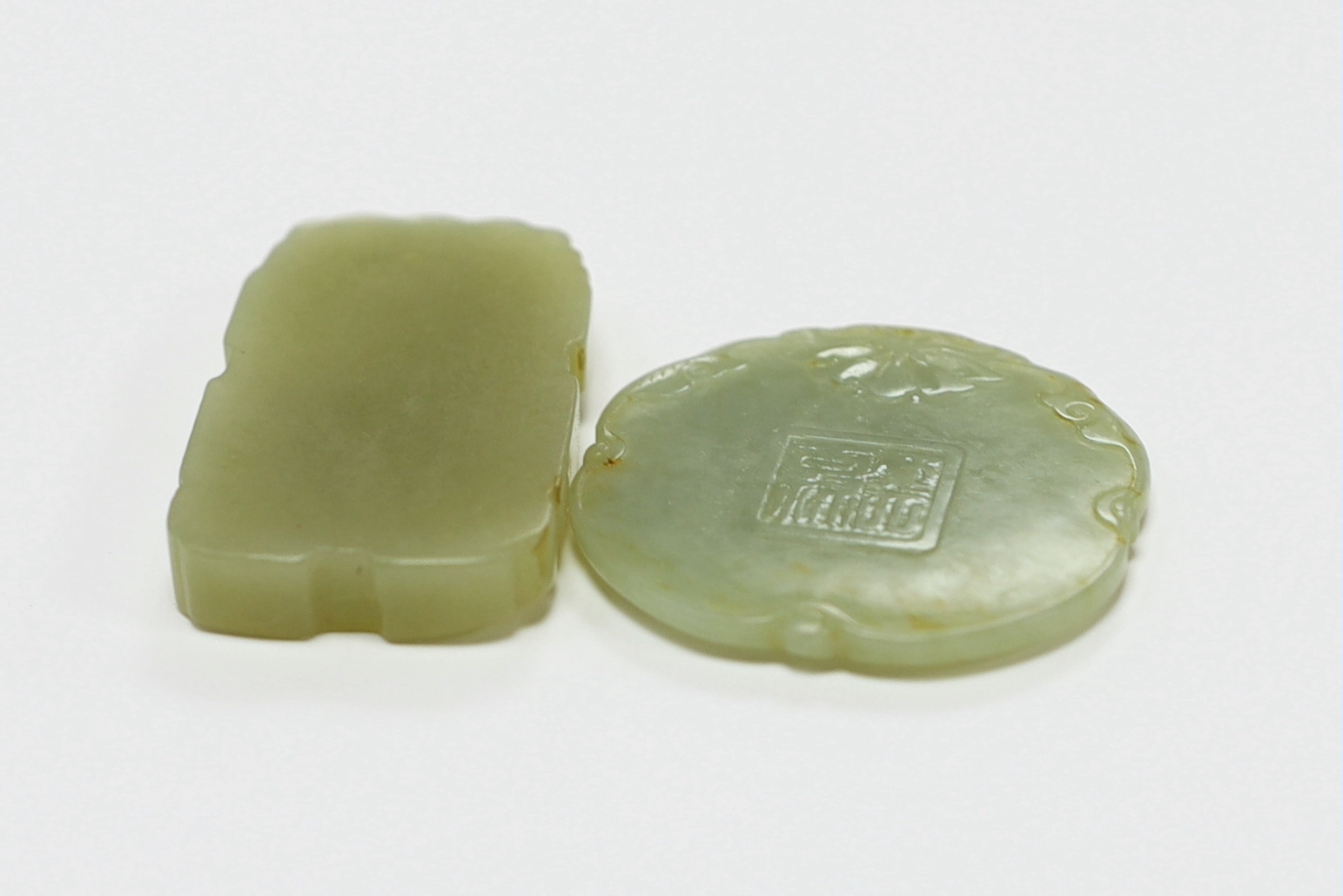 Two Chinese carved jade pendants, largest 6cm